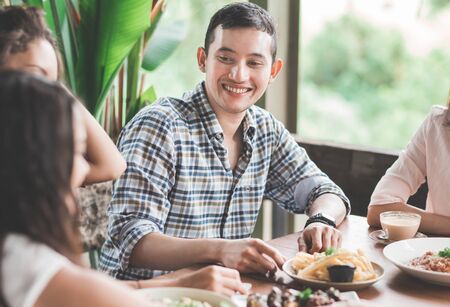 portrait of handsome man having lunch together with his bestfriends at cafeの写真素材