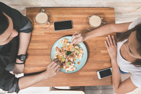 top view portrait of young couple having lunch together at coffee shopの写真素材