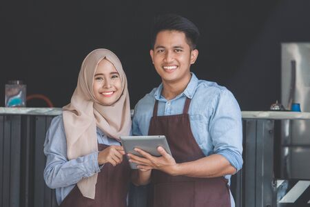 asian muslim business partner at their coffee shopの写真素材