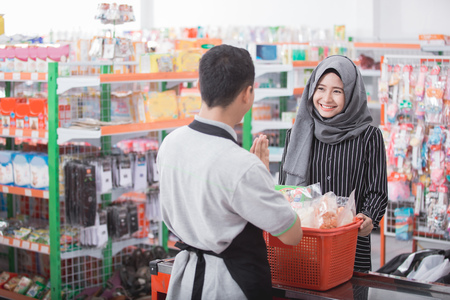 attractive female muslim customer buy some product at supermarketの写真素材