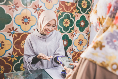 customer put her secret number while pay using credit card at fashion storeの写真素材