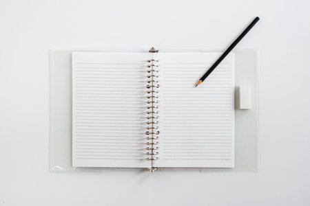 blank notebook with pencil and eraser