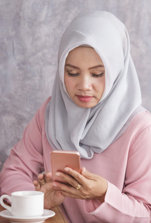 beautiful muslim women busy on her mobilephone