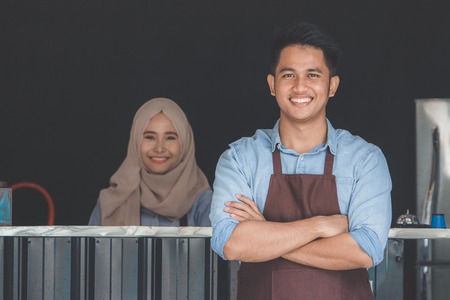 cafe owner standing with crossed armsの写真素材