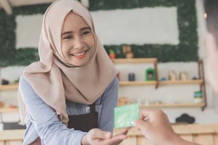 customer paying his bills using credit cardの写真素材