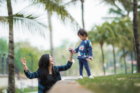 mother and daughter walking in the gardenの写真素材