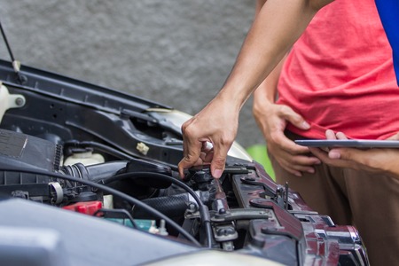 technician checking carburetorの写真素材