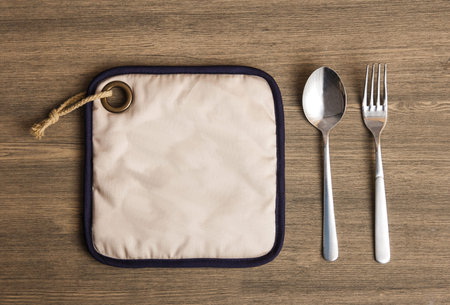 portrait of stainless spoon and fork on wooden table