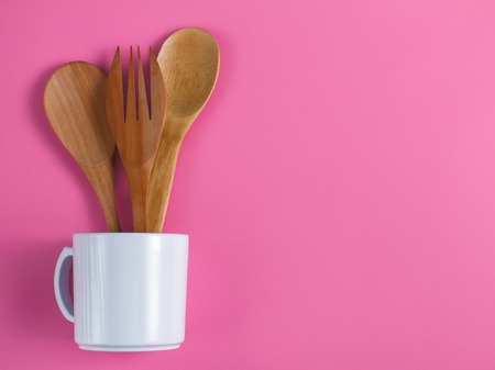 wooden kitchen utensils in white mugの写真素材