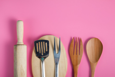 different kitchen tools on pink backgroundの写真素材