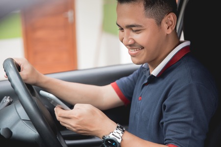 mobile phone while drivingの写真素材