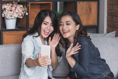 Two female friends video callの写真素材