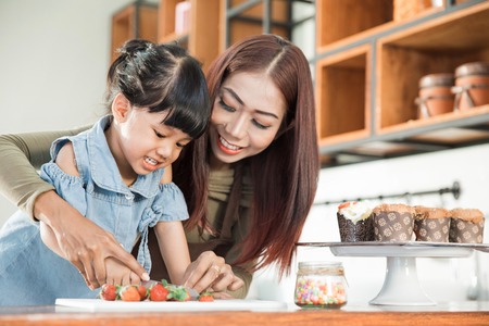 kid with parent cooking time in the kitchenの写真素材