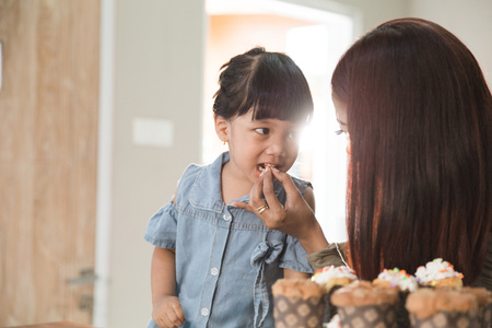 kid with parent cooking time in the kitchenの写真素材