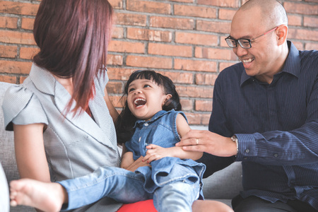 kid enjoying with parentの写真素材