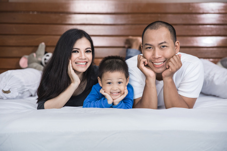 happy asian family in the bedの写真素材