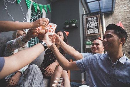 Group of friends enjoying party and cheers. celebrating and singing togetherの写真素材