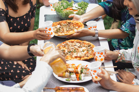 Group of friends enjoying meal at outdoor party in backyard. focus on food