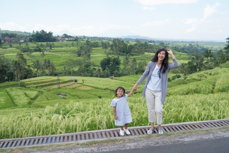 mother and daughter enjoy paddy rice field viewの写真素材