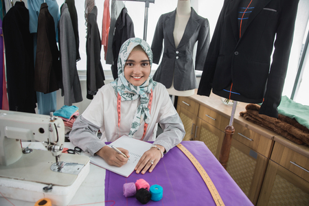 woman tailor using sewing machineの写真素材