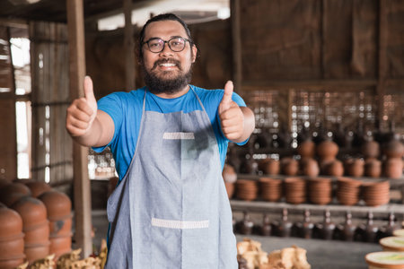 pottery maker showing thumbs up