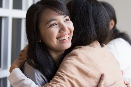 woman embracing each otherの写真素材