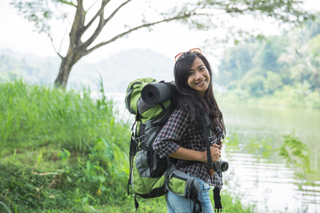 asian woman hiker with backpackの写真素材