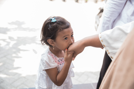 kid shaking hand and apologizingの写真素材