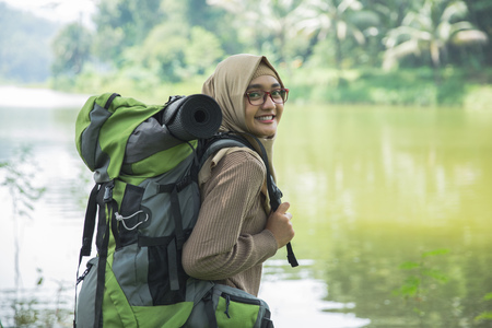 muslim asian woman hiker with backpackの写真素材
