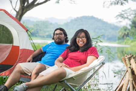 couple having fun enjoying nature while campingの写真素材