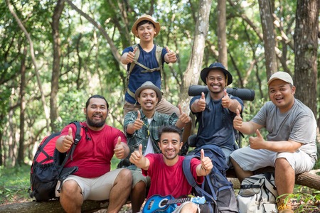 group of a hiker sitting down and showing thumb upの写真素材