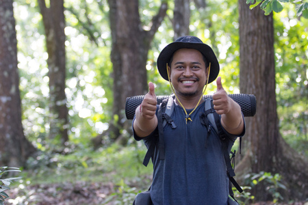 male hiker thumb upの写真素材