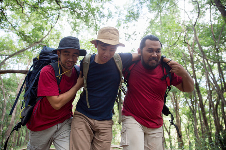 support friend to walk while hikingの写真素材