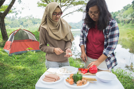 preparing food with skewers during outingの写真素材