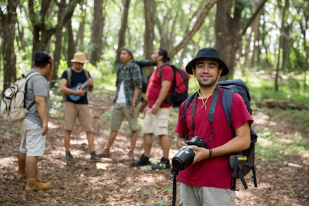 hiker with backpack holding cameraの写真素材