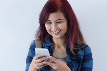 Close up female redhead college student holding handphone