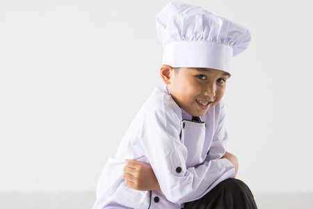 Cute boy in chef uniform poseの写真素材