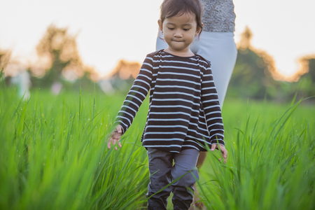 happy young asian enjoying their time in paddy rice fieldの写真素材
