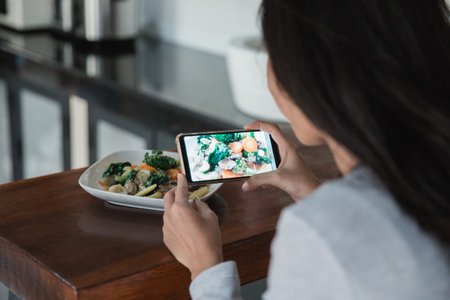 woman taking picture of food