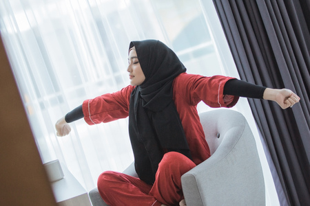 asian muslim woman streching her armの写真素材