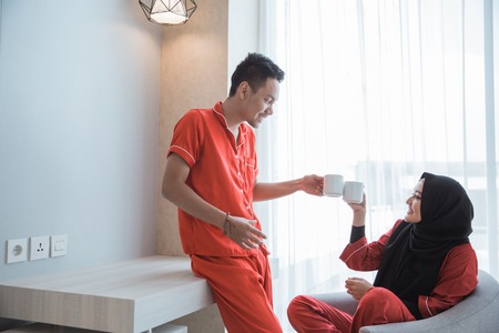 muslim couple having a cup of coffeeの写真素材