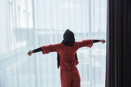 asian muslim woman streching her armの写真素材