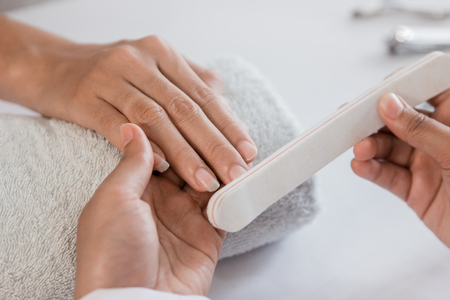 Young woman is getting manicureの写真素材