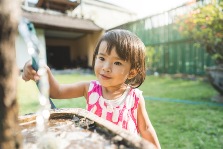 beautiful little child watering the plantsの写真素材