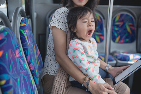 woman is holding her daughter yawnsの写真素材