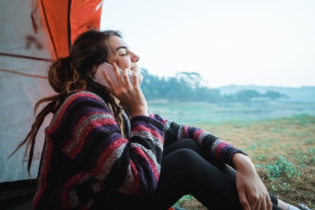 close up a woman with smartphone after wake upの写真素材