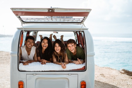 young people enjoy holiday lay down relax inside vintage vanの写真素材