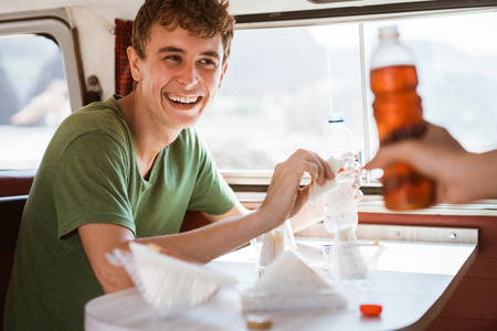 hipster having fun inside retro van on tripの写真素材