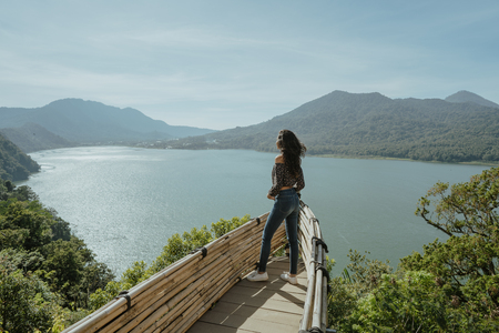 stylish young woman taking picture for social media in natureの写真素材