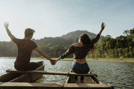 couple with traditional canoe together on a lakeの写真素材